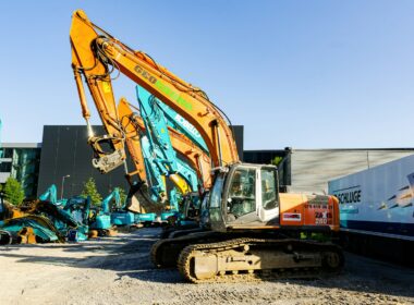 orange and white heavy equipment on gray concrete floor during daytime